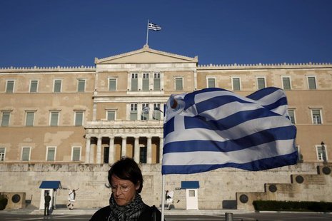 A protester stands in front of the parliament during an anti-government rally outside the parliament in Athens March 30, 2014. REUTERS/Yorgo A protester stands in front of the parliament during an anti-government rally outside the parliament in Athens March 30, 2014. REUTERS/Yorgo