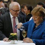 German Chancellor Angela Merkel, leader of the Christian Democratic Union (CDU), speaks with CDU faction leader Volker Kauder after signing German Chancellor Angela Merkel, leader of the Christian Democratic Union (CDU), speaks with CDU faction leader Volker Kauder after signing