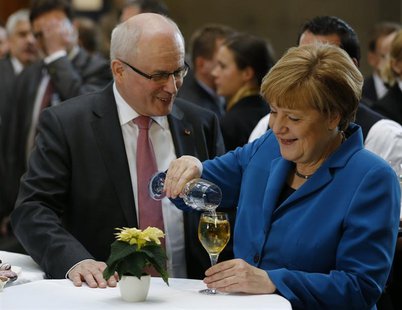 German Chancellor Angela Merkel, leader of the Christian Democratic Union (CDU), speaks with CDU faction leader Volker Kauder after signing German Chancellor Angela Merkel, leader of the Christian Democratic Union (CDU), speaks with CDU faction leader Volker Kauder after signing