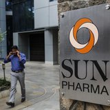 An employee speaks on phone as he walks out of research and development centre of Sun Pharmaceutical Industries Ltd in Mumbai April 7, 2014. An employee speaks on phone as he walks out of research and development centre of Sun Pharmaceutical Industries Ltd in Mumbai April 7, 2014.