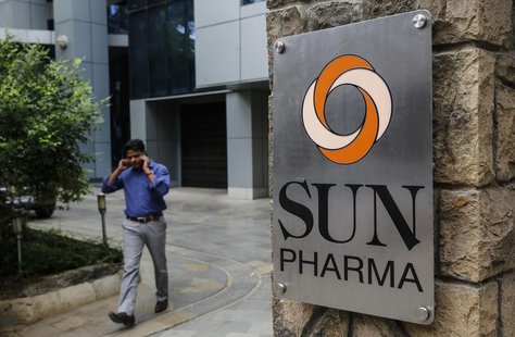 An employee speaks on phone as he walks out of research and development centre of Sun Pharmaceutical Industries Ltd in Mumbai April 7, 2014. An employee speaks on phone as he walks out of research and development centre of Sun Pharmaceutical Industries Ltd in Mumbai April 7, 2014.