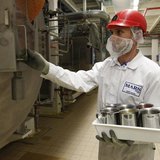 An employee holds a tray of M&M's candies at the production line of candy and chocolate maker Mars Chocolate France's plant in Haguenau, eas An employee holds a tray of M&M's candies at the production line of candy and chocolate maker Mars Chocolate France's plant in Haguenau, eas