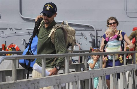 Eric and Charlotte Kaufman and their two daughters, 3-year-old Cora and 1-year-old Lyra, disembark the USS Vandegrift in San Diego April 9, Eric and Charlotte Kaufman and their two daughters, 3-year-old Cora and 1-year-old Lyra, disembark the USS Vandegrift in San Diego April 9,