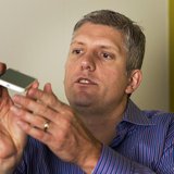 Rick Osterloh, senior vice president of product management for Motorola Mobility, describes the size of Motorola's new Moto X phone at a lau Rick Osterloh, senior vice president of product management for Motorola Mobility, describes the size of Motorola's new Moto X phone at a lau
