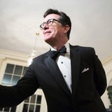 Comedian Stephen Colbert greets a reporter as he arrives for the State Dinner being held for French President Francois Hollande at the White Comedian Stephen Colbert greets a reporter as he arrives for the State Dinner being held for French President Francois Hollande at the White