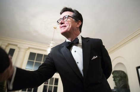 Comedian Stephen Colbert greets a reporter as he arrives for the State Dinner being held for French President Francois Hollande at the White Comedian Stephen Colbert greets a reporter as he arrives for the State Dinner being held for French President Francois Hollande at the White