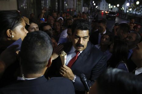 Venezuela's President Nicolas Maduro (C) greets supporters after his meeting with representatives of the Venezuelan coalition of opposition Venezuela's President Nicolas Maduro (C) greets supporters after his meeting with representatives of the Venezuelan coalition of opposition