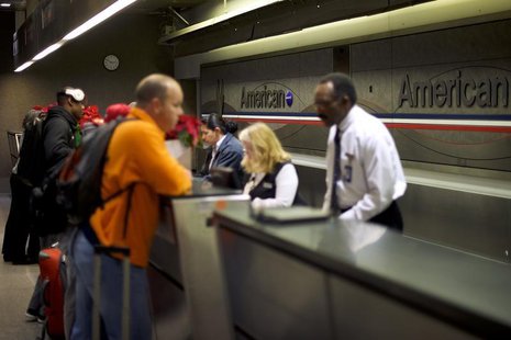Employees check in travelers at the American Airlines check in counters at Philadelphia International Airport in Philadelphia, Pennsylvania Employees check in travelers at the American Airlines check in counters at Philadelphia International Airport in Philadelphia, Pennsylvania