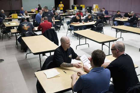 Members of the International Association of Machinists and Aerospace Workers from District 751 count votes at their union hall in Seattle, W Members of the International Association of Machinists and Aerospace Workers from District 751 count votes at their union hall in Seattle, W