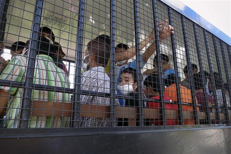 Suspected Uighurs are transported back to a detention facility in the town of Songkhla in southern Thailand after visiting women and childre Suspected Uighurs are transported back to a detention facility in the town of Songkhla in southern Thailand after visiting women and childre