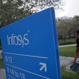 An employees walks past a signage board in the Infosys campus at the Electronics City IT district in Bangalore, February 28, 2012. REUTERS/V An employees walks past a signage board in the Infosys campus at the Electronics City IT district in Bangalore, February 28, 2012. REUTERS/V