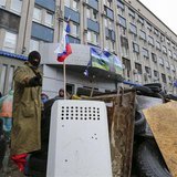 A pro-Russian protester gestures as he stands guard at a barricade in front of the seized office of the SBU state security service in Luhans A pro-Russian protester gestures as he stands guard at a barricade in front of the seized office of the SBU state security service in Luhans