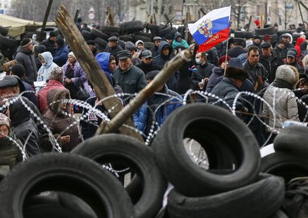 Pro-Russia protesters gather in front of a barricade outside a regional government building in Donetsk, in eastern Ukraine April 11, 2014. R Pro-Russia protesters gather in front of a barricade outside a regional government building in Donetsk, in eastern Ukraine April 11, 2014. R