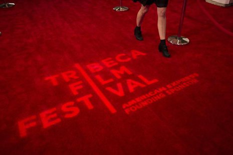 A woman walks past a logo displayed on a red carpet on the opening night of the Tribeca Film Festival in New York, April 17, 2013. REUTERS/L A woman walks past a logo displayed on a red carpet on the opening night of the Tribeca Film Festival in New York, April 17, 2013. REUTERS/L