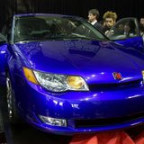 Members of the press look over the new 2003 Saturn ION quad coup at its debut at the New York International Auto Show in New York on March 2 Members of the press look over the new 2003 Saturn ION quad coup at its debut at the New York International Auto Show in New York on March 2