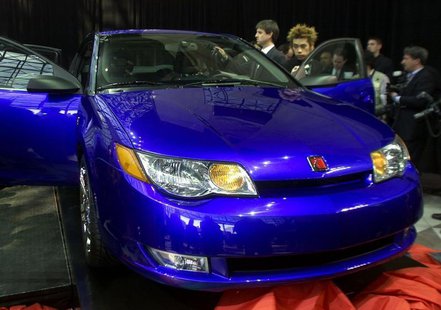 Members of the press look over the new 2003 Saturn ION quad coup at its debut at the New York International Auto Show in New York on March 2 Members of the press look over the new 2003 Saturn ION quad coup at its debut at the New York International Auto Show in New York on March 2