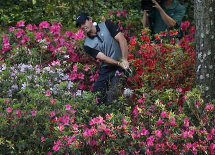 Northern Ireland's Rory McIlroy hits from the azaleas on the 13th hole during the second round of the Masters golf tournament at the Augusta Northern Ireland's Rory McIlroy hits from the azaleas on the 13th hole during the second round of the Masters golf tournament at the Augusta
