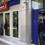 A customer leaves a Eurobank branch in Athens April 10, 2013. REUTERS/John Kolesidis A customer leaves a Eurobank branch in Athens April 10, 2013. REUTERS/John Kolesidis