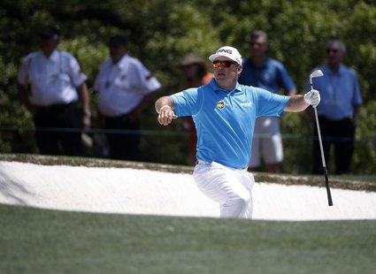 Britain's Lee Westwood climbs from the sand trap after a shot on the first hole during the third round of the Masters golf tournament at the Britain's Lee Westwood climbs from the sand trap after a shot on the first hole during the third round of the Masters golf tournament at the