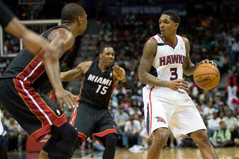 Apr 12, 2014; Atlanta, GA, USA; Miami Heat guard Mario Chalmers (15) defends Atlanta Hawks guard Louis Williams (3) during the fourth quarte Apr 12, 2014; Atlanta, GA, USA; Miami Heat guard Mario Chalmers (15) defends Atlanta Hawks guard Louis Williams (3) during the fourth quarte