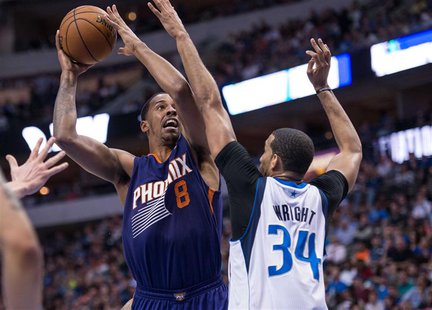 Apr 12, 2014; Dallas, TX, USA; Dallas Mavericks forward Brandan Wright (34) defends against Phoenix Suns forward Channing Frye (8) during th Apr 12, 2014; Dallas, TX, USA; Dallas Mavericks forward Brandan Wright (34) defends against Phoenix Suns forward Channing Frye (8) during th