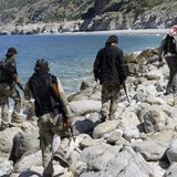 Rebel fighters walk with their weapons at the beach in Latakia province near the town of Kasab April 5, 2014. Picture taken April 5, 2014. R Rebel fighters walk with their weapons at the beach in Latakia province near the town of Kasab April 5, 2014. Picture taken April 5, 2014. R