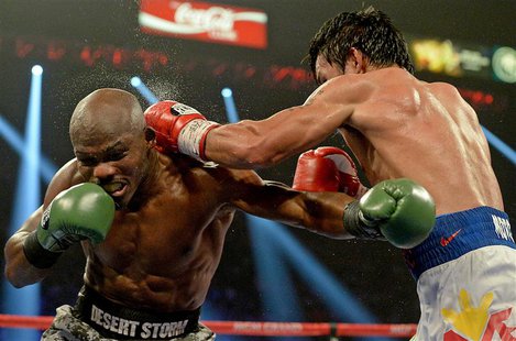 Apr 12, 2014; Las Vegas, NV, USA; Timothy Bradley Jr.(brown gloves) and Manny Pacquiao (red gloves) during their WBO World Welterweight Cham Apr 12, 2014; Las Vegas, NV, USA; Timothy Bradley Jr.(brown gloves) and Manny Pacquiao (red gloves) during their WBO World Welterweight Cham