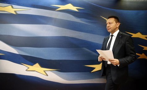 Greece's Finance Minister Yannis Stournaras arrives for a news briefing following his meeting with European Competition Commissioner Joaquin Greece's Finance Minister Yannis Stournaras arrives for a news briefing following his meeting with European Competition Commissioner Joaquin