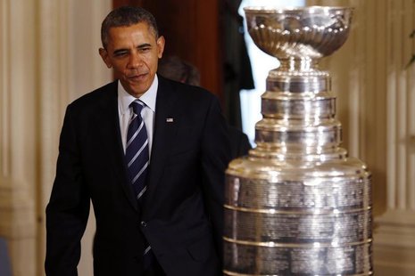 United States president Barack Obama enters the East Room behind the Stanley Cup prior to an event honoring the 2013 NHL Stanley Cup champio United States president Barack Obama enters the East Room behind the Stanley Cup prior to an event honoring the 2013 NHL Stanley Cup champio