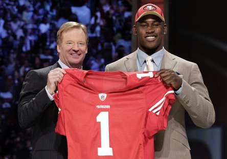 Defensive end Aldon Smith of the University of Missouri stands with NFL Commissioner Roger Goodell after being selected as the seventh overa Defensive end Aldon Smith of the University of Missouri stands with NFL Commissioner Roger Goodell after being selected as the seventh overa