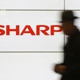 A pedestrian walks past a logo of Sharp Corp at a train station in Tokyo February 3, 2014. REUTERS/Yuya Shino A pedestrian walks past a logo of Sharp Corp at a train station in Tokyo February 3, 2014. REUTERS/Yuya Shino