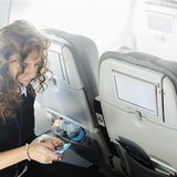 A woman uses her mobile phone to test a new high speed inflight Internet service named Fli-Fi while on a special JetBlue media flight out of A woman uses her mobile phone to test a new high speed inflight Internet service named Fli-Fi while on a special JetBlue media flight out of