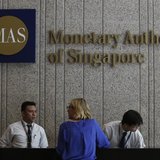 A visitor speaks to security officers at the building of the Monetary Authority of Singapore (MAS) in Singapore February 21, 2013. REUTERS/E A visitor speaks to security officers at the building of the Monetary Authority of Singapore (MAS) in Singapore February 21, 2013. REUTERS/E