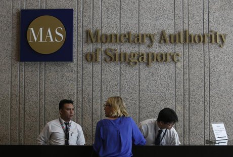 A visitor speaks to security officers at the building of the Monetary Authority of Singapore (MAS) in Singapore February 21, 2013. REUTERS/E A visitor speaks to security officers at the building of the Monetary Authority of Singapore (MAS) in Singapore February 21, 2013. REUTERS/E