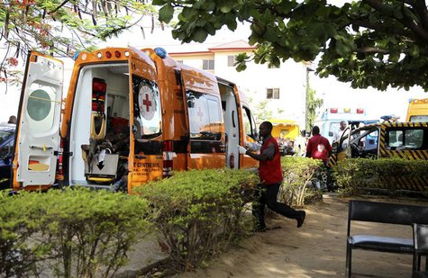 A Red Cross worker runs towards an ambulance carrying victims of a bomb blast at the Asokoro General Hospital in Abuja April 14, 2014. REUTE A Red Cross worker runs towards an ambulance carrying victims of a bomb blast at the Asokoro General Hospital in Abuja April 14, 2014. REUTE