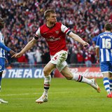 Arsenal's Per Mertesacker celebrates his goal against Wigan Athletic during their English FA Cup semi-final soccer match at Wembley Stadium Arsenal's Per Mertesacker celebrates his goal against Wigan Athletic during their English FA Cup semi-final soccer match at Wembley Stadium