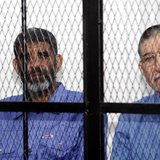 Abdullah al-Senussi (L), ex-spy chief in Muammar Gaddafi's government and Buzeid Dorda, ex-intelligence chief, sit behind bars during a hear Abdullah al-Senussi (L), ex-spy chief in Muammar Gaddafi's government and Buzeid Dorda, ex-intelligence chief, sit behind bars during a hear