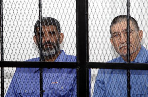 Abdullah al-Senussi (L), ex-spy chief in Muammar Gaddafi's government and Buzeid Dorda, ex-intelligence chief, sit behind bars during a hear Abdullah al-Senussi (L), ex-spy chief in Muammar Gaddafi's government and Buzeid Dorda, ex-intelligence chief, sit behind bars during a hear