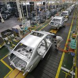 Employees assemble cars at a production line of Dongfeng Peugeot Citroen Automobile factory in Wuhan, Hubei province, February 13, 2014. REU Employees assemble cars at a production line of Dongfeng Peugeot Citroen Automobile factory in Wuhan, Hubei province, February 13, 2014. REU