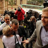 Olympic and Paralympic track star Oscar Pistorius is hugged by a supporter as he arrives ahead of his trial at the North Gauteng High Court Olympic and Paralympic track star Oscar Pistorius is hugged by a supporter as he arrives ahead of his trial at the North Gauteng High Court