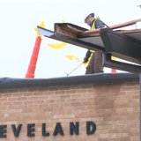 Crews repair part of the roof of Cleveland Elementary School after a storm damaged the region on April 13, 2014. (Photo from: YouTube). Crews repair part of the roof of Cleveland Elementary School after a storm damaged the region on April 13, 2014. (Photo from: YouTube).