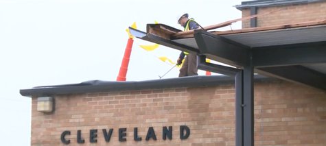 Crews repair part of the roof of Cleveland Elementary School after a storm damaged the region on April 13, 2014. (Photo from: YouTube). Crews repair part of the roof of Cleveland Elementary School after a storm damaged the region on April 13, 2014. (Photo from: YouTube).