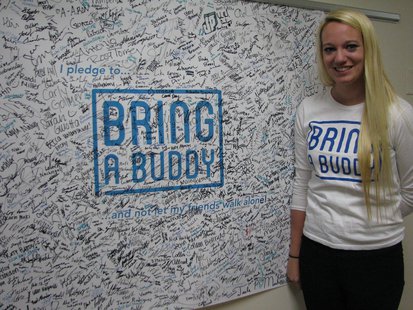 Jenna Furger with the UWSP Bring A Buddy banner, where over 1,500 students have pledged to bring a buddy instead of going out alone. Jenna Furger with the UWSP Bring A Buddy banner, where over 1,500 students have pledged to bring a buddy instead of going out alone.