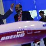 Visitors talk next to a Boeing 777X aircraft model at the Singapore Airshow February 13, 2014. REUTERS/Edgar Su Visitors talk next to a Boeing 777X aircraft model at the Singapore Airshow February 13, 2014. REUTERS/Edgar Su