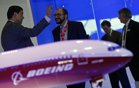 Visitors talk next to a Boeing 777X aircraft model at the Singapore Airshow February 13, 2014. REUTERS/Edgar Su Visitors talk next to a Boeing 777X aircraft model at the Singapore Airshow February 13, 2014. REUTERS/Edgar Su