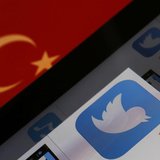 A Twitter logo on an iPad display is pictured next to a Turkish flag in this photo illustration taken in Istanbul March 21, 2014. REUTERS/Mu A Twitter logo on an iPad display is pictured next to a Turkish flag in this photo illustration taken in Istanbul March 21, 2014. REUTERS/Mu