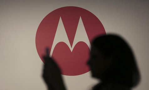 A woman takes a picture in front of a Motorola logo before the worldwide presentation of the Moto G mobile phone in Sao Paulo November 13, 2 A woman takes a picture in front of a Motorola logo before the worldwide presentation of the Moto G mobile phone in Sao Paulo November 13, 2