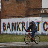 A man rides his bike past graffiti that reads "Bankruptcy" in Detroit, Michigan, December 3, 2013. REUTERS/Joshua Lott A man rides his bike past graffiti that reads "Bankruptcy" in Detroit, Michigan, December 3, 2013. REUTERS/Joshua Lott