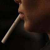 A model holds an unlit cigarette in her mouth backstage before the Zang Toi Spring 2011 collection during New York Fashion Week September 15 A model holds an unlit cigarette in her mouth backstage before the Zang Toi Spring 2011 collection during New York Fashion Week September 15