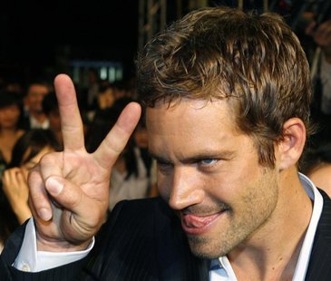 U.S. actor Paul Walker gestures to a fan during the premiere of the movie "Fast and Furious 4" in Taipei April 15, 2009. REUTERS/Nicky Loh U.S. actor Paul Walker gestures to a fan during the premiere of the movie "Fast and Furious 4" in Taipei April 15, 2009. REUTERS/Nicky Loh